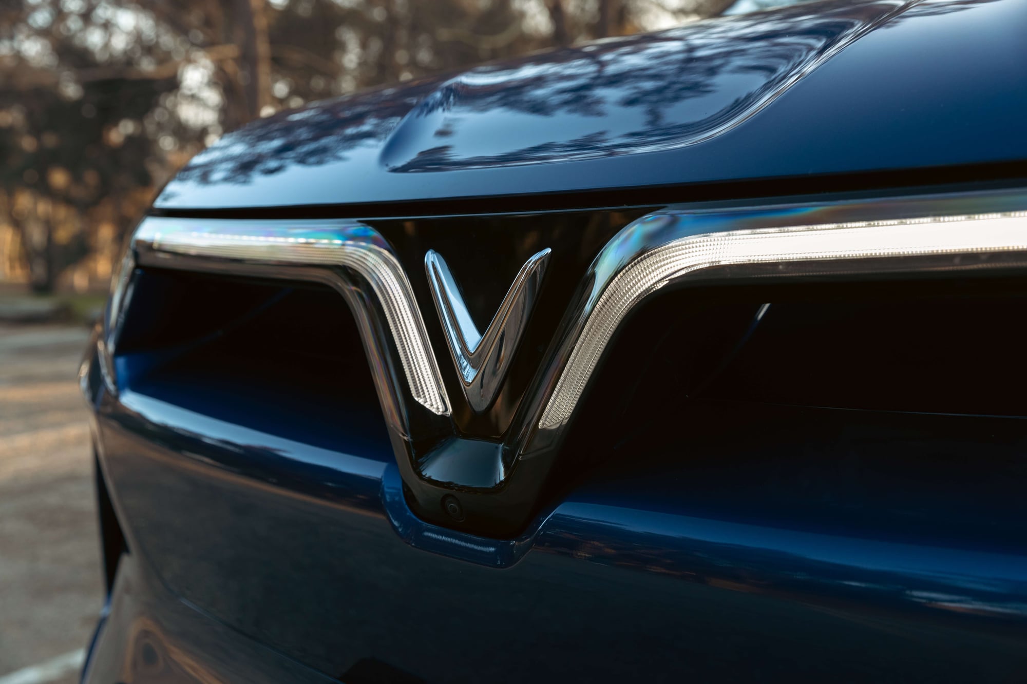 Close-up of the VinFast VF 9 front light bar and V emblem